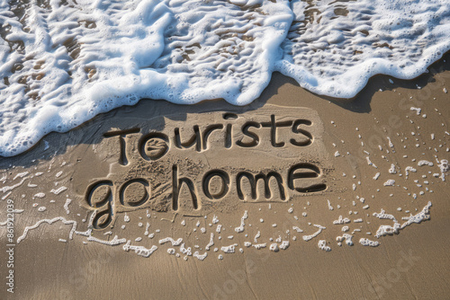 Tourists go home anti tourism message written in the sand on a beach. Generative ai
