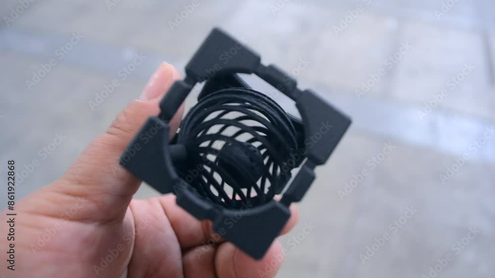 A person holding in his hand an object printed on a 3D printer ...