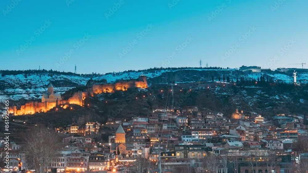 Tbilisi, Georgia. Scenic View Of Park Rike In Tbilisi, Georgia. Metekhi Church, Narikala Fortress, Old Historic District Of Kala, Cableway, air balloon viewpoint. Urban Night Cityscape. Evening Scenic Tbilisi, Georgia. Scenic View Of Park Rike In Tbilisi, Georgia. Metekhi Church, Narikala Fortress, Old Historic District Of Kala, Cableway, air balloon viewpoint. Urban Night Cityscape. Evening Scenic