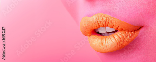 Close-up of female orange lips on pink background with space for text. Inspiration, idea, trendy urban magazine style. Negative space for text or advertisement. © Olesia Khazova