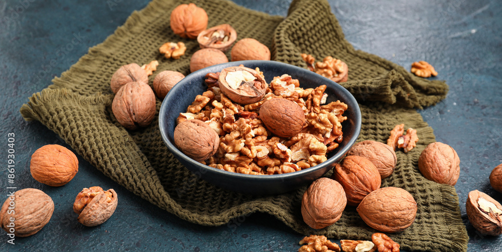 Bowl with tasty walnuts on black background Bowl with tasty walnuts on black background