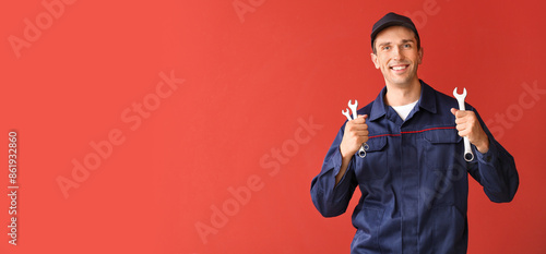 Male car mechanic on color ...
