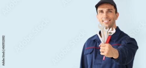 Male car mechanic on light ...