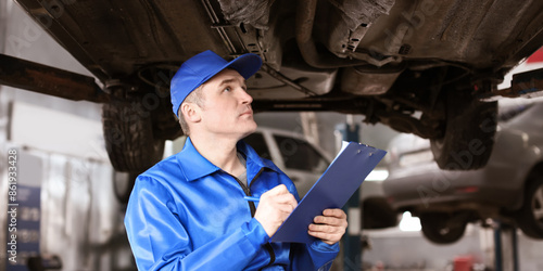Male mechanic with clipboar...