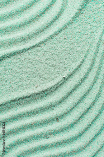 textured green sand background, beautiful sand texture, overhead view of green sand, zen pattern drawn in the sand, Top view of fine grain texture photo