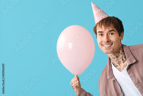 Young man in party hat with...