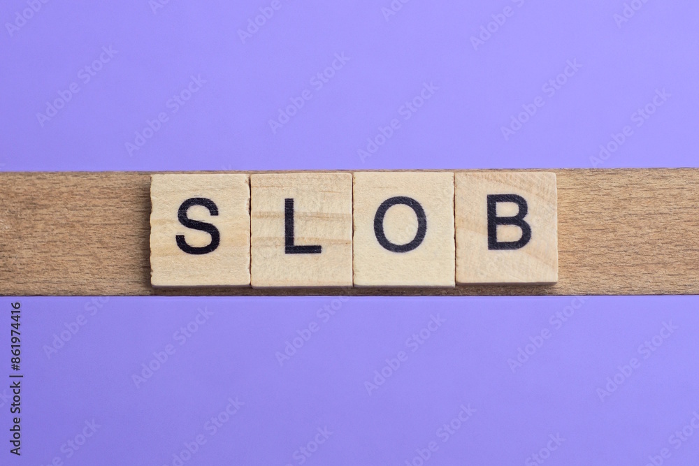 word slob made from wooden gray letters lies on a lilac background word slob made from wooden gray letters lies on a lilac background