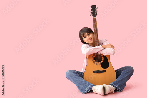 Pretty young woman with gui...