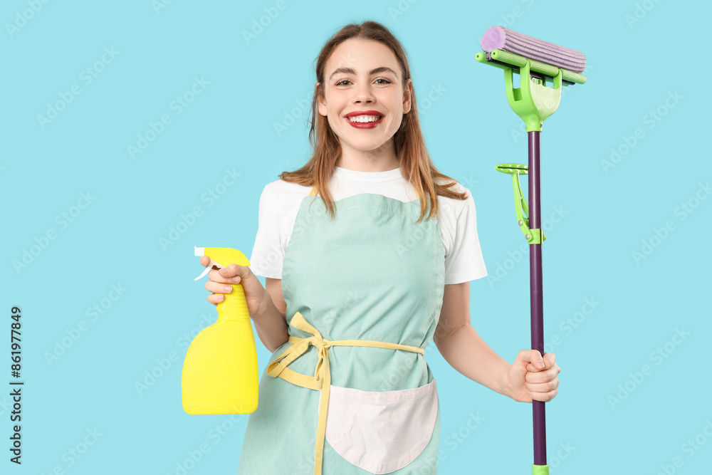 Pretty woman with mop and bottle of detergent on blue background Pretty woman with mop and bottle of detergent on blue background
