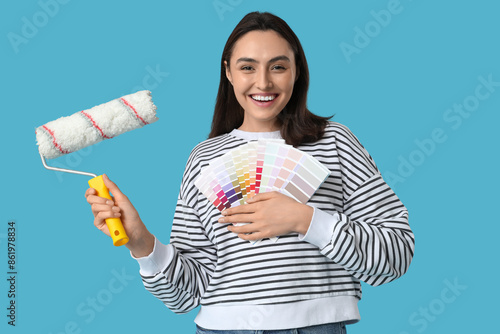 Smiling woman holding paint...