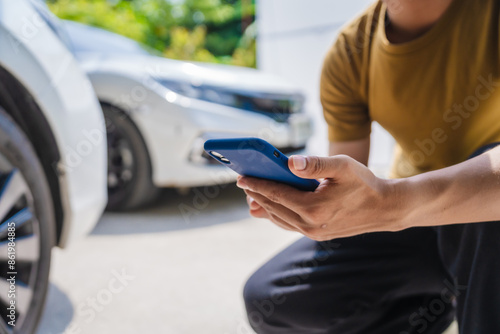 Fotografie Man fills out a car insurance form after a car accident