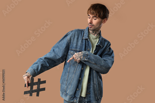 Cool tattooed young man wit...