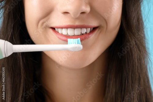 Smiling young woman with el...