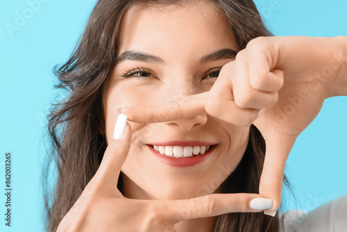 Smiling young woman making ...