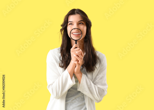 Smiling young woman magnify...