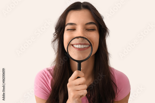 Smiling young woman magnify...
