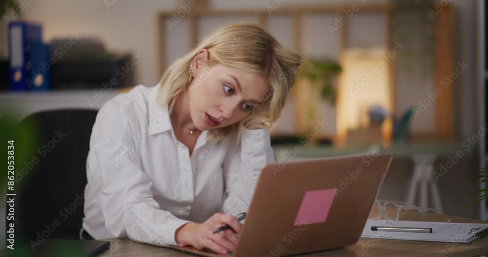 Overworked Woman Working Late on Laptop in Office Overworked Woman Working Late on Laptop in Office