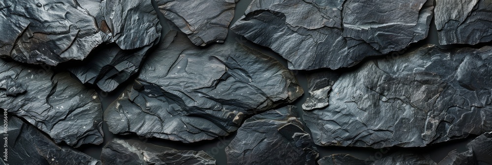 A closeup view of a dark slate stone texture that is perfect for backgrounds, textures, and natural material themes A closeup view of a dark slate stone texture that is perfect for backgrounds, textures, and natural material themes