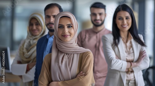 Beautiful arab middle-eastern women with traditional abaya dress and middle easter man wearing kandora standi in business office - Group of arabic muslim adults portrait in Dubai, United Arab Emirates