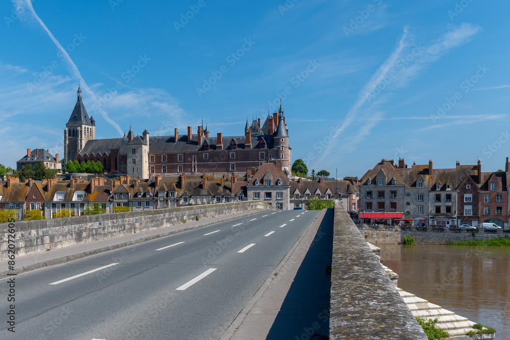 Obraz premium Views of old part of town of Gien is on the Loire river, in Loiret department, France, bridge and castle