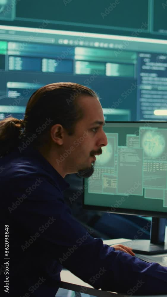 Vertical Video Cyber security experts in a governmental hacking room working on securing networks. Hackers focusing on malware detection, cyber operations and protection against digital mercenaries