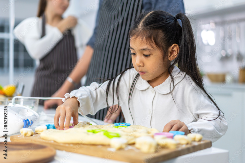 Portrait of enjoy happy love asian family mother and little toddler asian girl daughter child having fun cooking together with dough for homemade bake cookie and cake ingredient on table in kitchen Portrait of enjoy happy love asian family mother and little toddler asian girl daughter child having fun cooking together with dough for homemade bake cookie and cake ingredient on table in kitchen