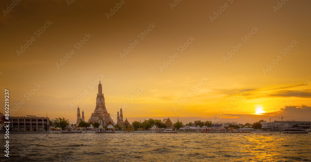 Wat Arun and Chapaya river panorama view at sunset, A Buddhist temple in Bangkok, Thailand, Wat Arun is one of the most well known of Thailand's landmarks Wat Arun and Chapaya river panorama view at sunset, A Buddhist temple in Bangkok, Thailand, Wat Arun is one of the most well known of Thailand's landmarks