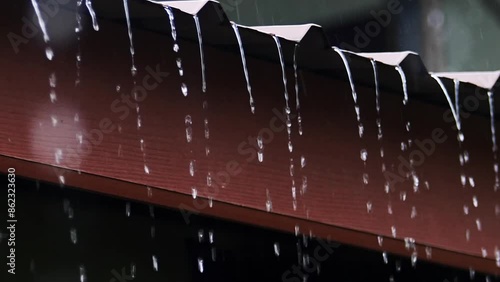 Rain drops from the roof for use as a background for global climate change weather forecasts. photo