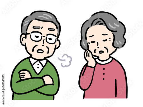 悩んでため息をつくシニア夫婦