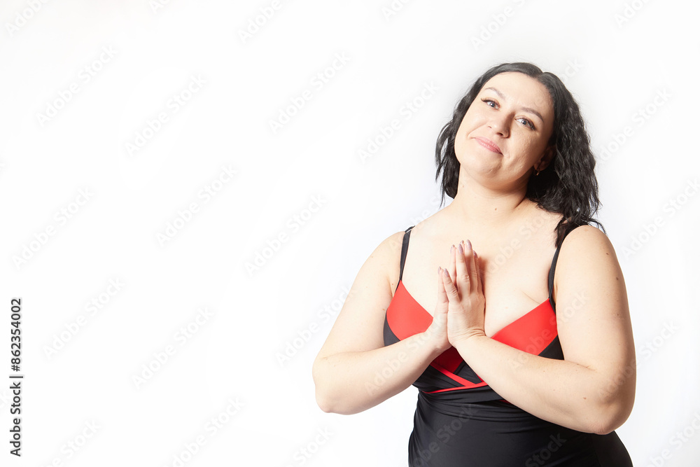 Portrait of attractive dreamy thick woman in red black swimsuit posing on white background. Body positive, photo shoot, selfie. Funny plus size model Portrait of attractive dreamy thick woman in red black swimsuit posing on white background. Body positive, photo shoot, selfie. Funny plus size model