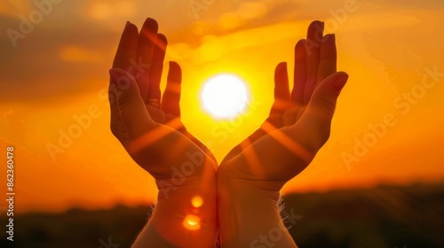 Hands holding the sun at dawn - inspiring nature backgroundwarm sunlight. photo