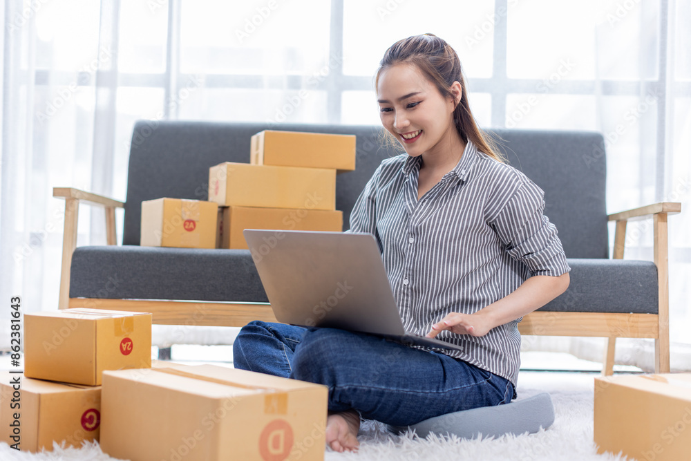 asian young woman owner packing product box prepare to the package for delivery to the customer on sofa at home office asian Entrepreneur SME business concept. asian young woman owner packing product box prepare to the package for delivery to the customer on sofa at home office asian Entrepreneur SME business concept.