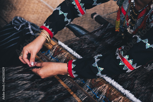 Indigenous woman AKA Dreamweaver from the south of the Philippines manually weaving the original and naturally dyed T'nalak cloth, made from quality Abaca plant fiber. Animal free native product. photo