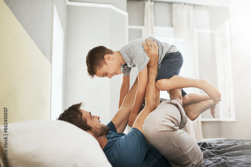 Happy dad, bed and playing with son for bonding, care or support together in morning at home. Father with playful child, kid or little boy in air for fun day, weekend or holiday in bedroom at house Happy dad, bed and playing with son for bonding, care or support together in morning at home. Father with playful child, kid or little boy in air for fun day, weekend or holiday in bedroom at house