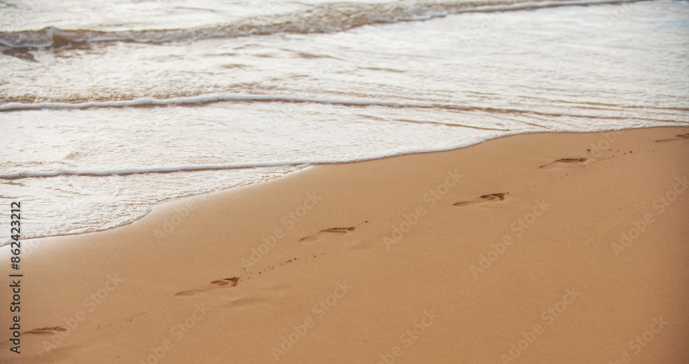 Footprints at golden sand, footsteps. Beach with golden sand, turquoise ocean water. Panoramic sea view. Natural background for summer vacation. Footprints at golden sand, footsteps. Beach with golden sand, turquoise ocean water. Panoramic sea view. Natural background for summer vacation.