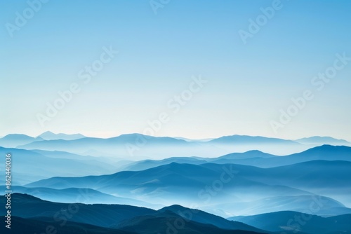 A breathtaking view of a distant mountain range with layered peaks under a clear sky, showcasing natural beauty and serene landscapes