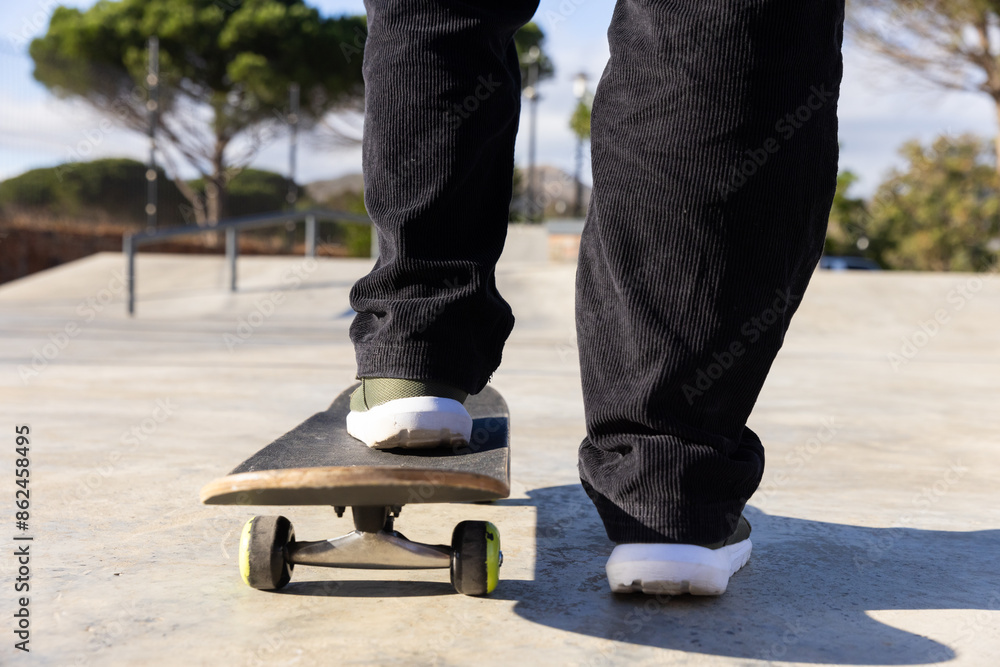 Skateboarding at park, male student balancing on skateboard, enjoying outdoor activity Skateboarding at park, male student balancing on skateboard, enjoying outdoor activity