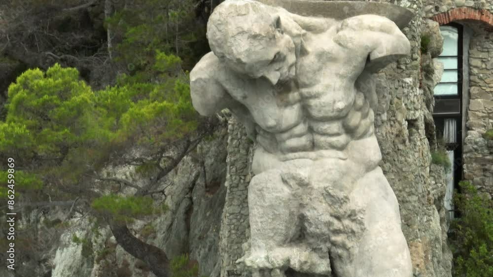 Il Gigante statue, also known as Monterosso Giant, in Monterosso al Mare, Italy with drone video close up parallax in a circle. Il Gigante statue, also known as Monterosso Giant, in Monterosso al Mare, Italy with drone video close up parallax in a circle.