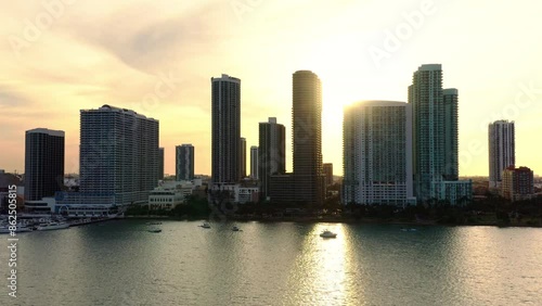 The stunning beauty cinematic footage of Miami from a birdseye view during the magical golden hour, gazing at the impressive skyline, tall buildings, and sparkling waterfront. 4k footage from drone