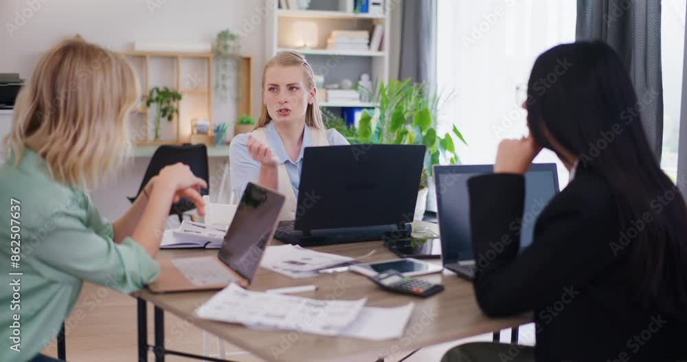 Three Female Employees Discuss Project During Meeting Three Female Employees Discuss Project During Meeting