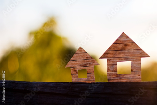 Conceptual paper houses isolated on sunset sky