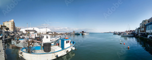 Anzio Harbor panoramic view with many fishing boats moored and ready to fish in mediterranean sea photo