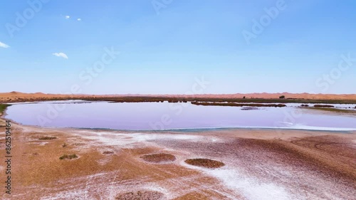 Aerial establishing shot of Wulan Lake in the Tengger Desert in China photo