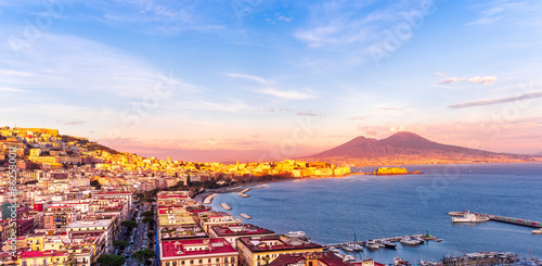 beautiful panorama of Naples city with amazing coast, sea port, streets and buildings and volcano Vesuvius with anazing sky on background photo