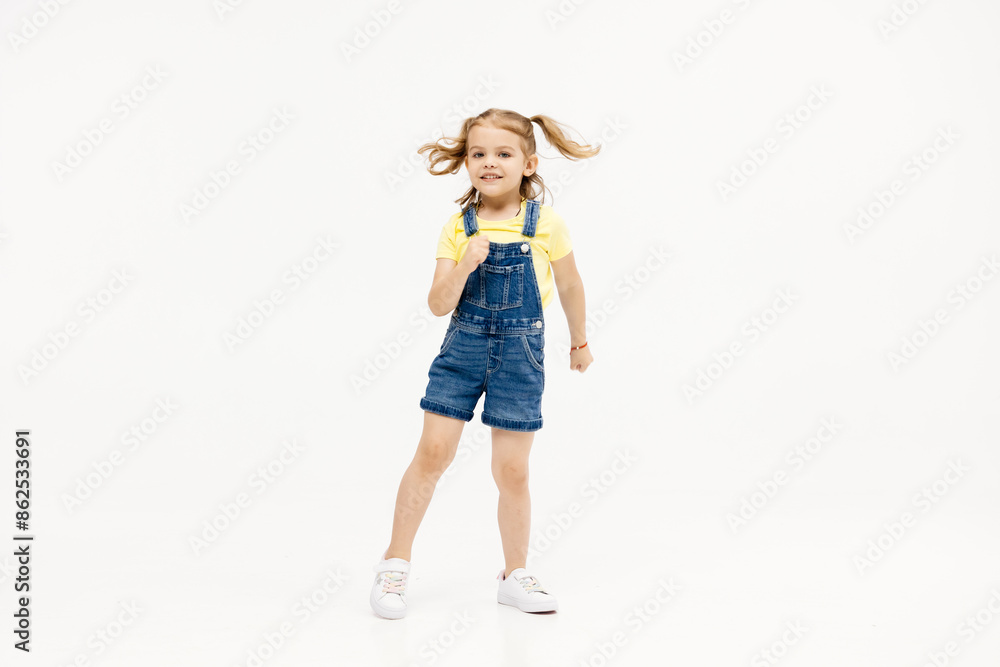 Happy smiling child having fun on white studio background. The concept of childhood and childish emotions. Happy smiling child having fun on white studio background. The concept of childhood and childish emotions.