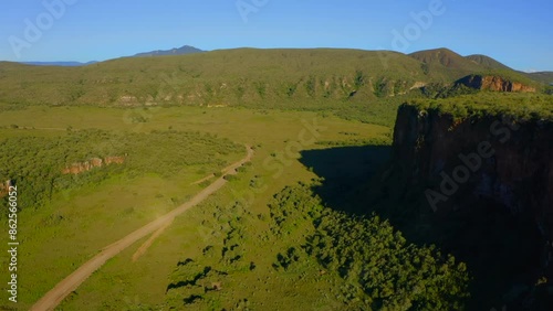 Colorful a spectacular aerial perspective of Hells Gate National Park in Kenya, revealing its verdant landscape, towering cliffs, and vast panoramas beneath a pristine blue sky. Africa.