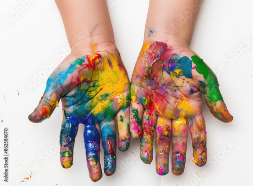 The hands of a child are adorned with vibrant paint colors