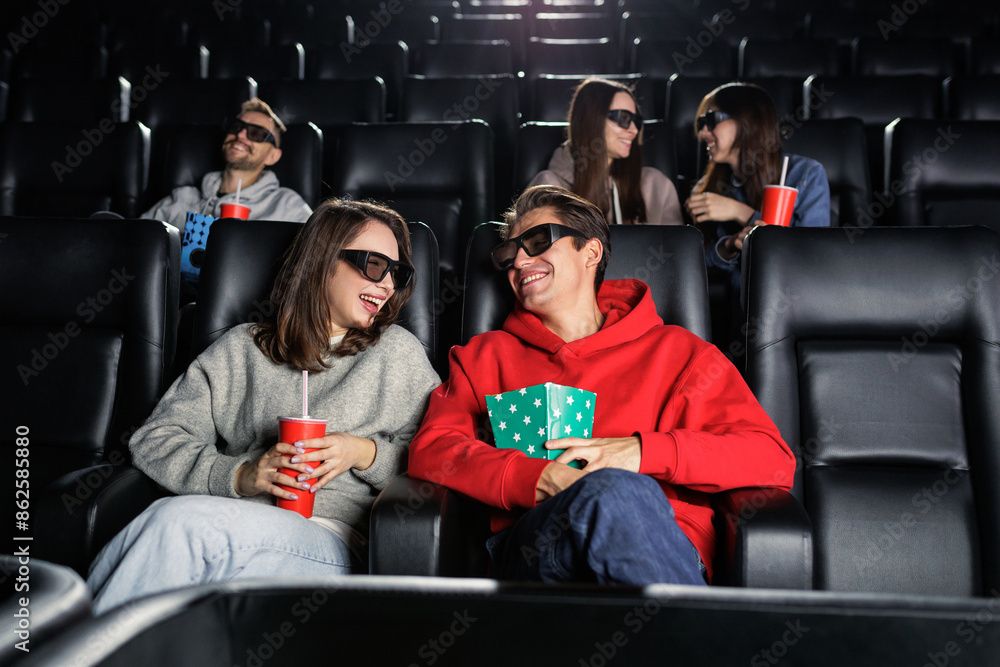 Φωτογραφία A group of friends who are laughing at the premiere of a comedy in the cinema