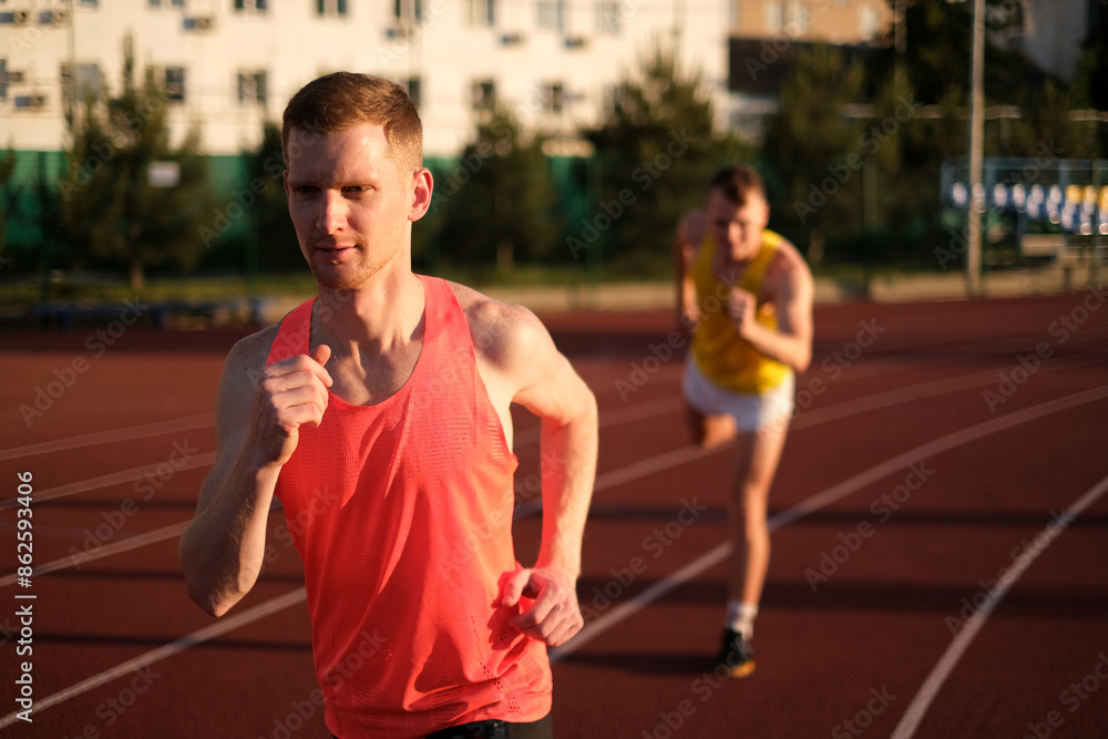 Athletes compete in running at the stadium Athletes compete in running at the stadium