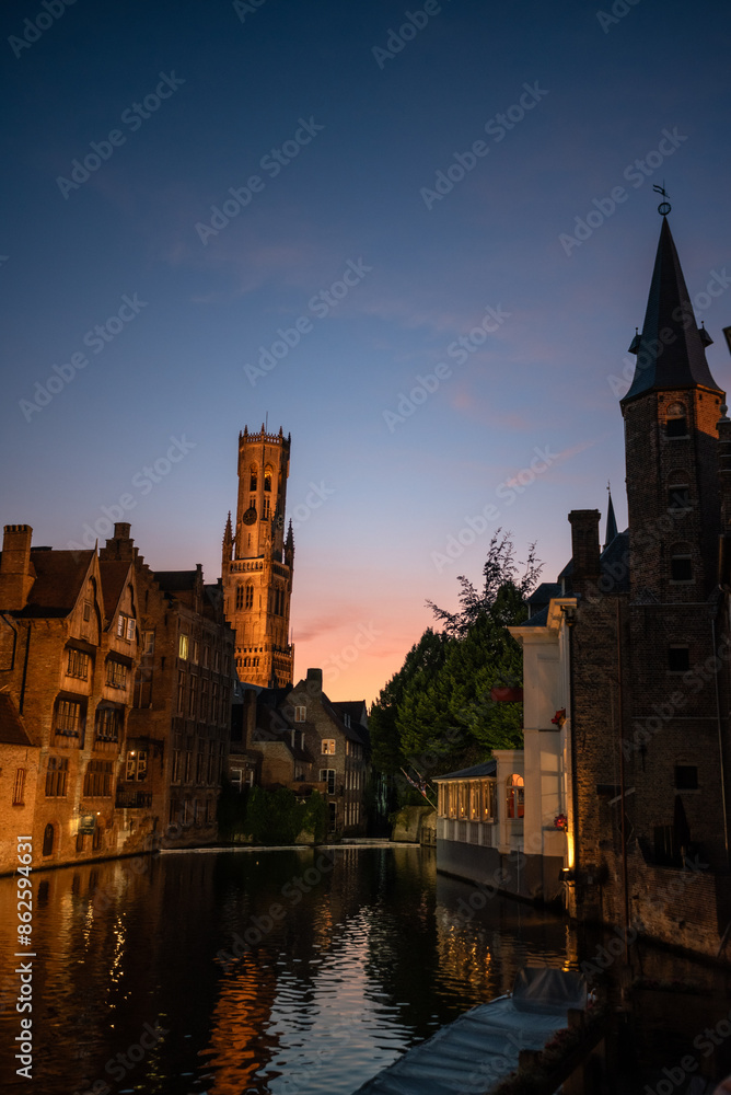 Fototapeta premium Medieval Bruges: Rozenhoedkaai and Belfry at Dusk - Belgium